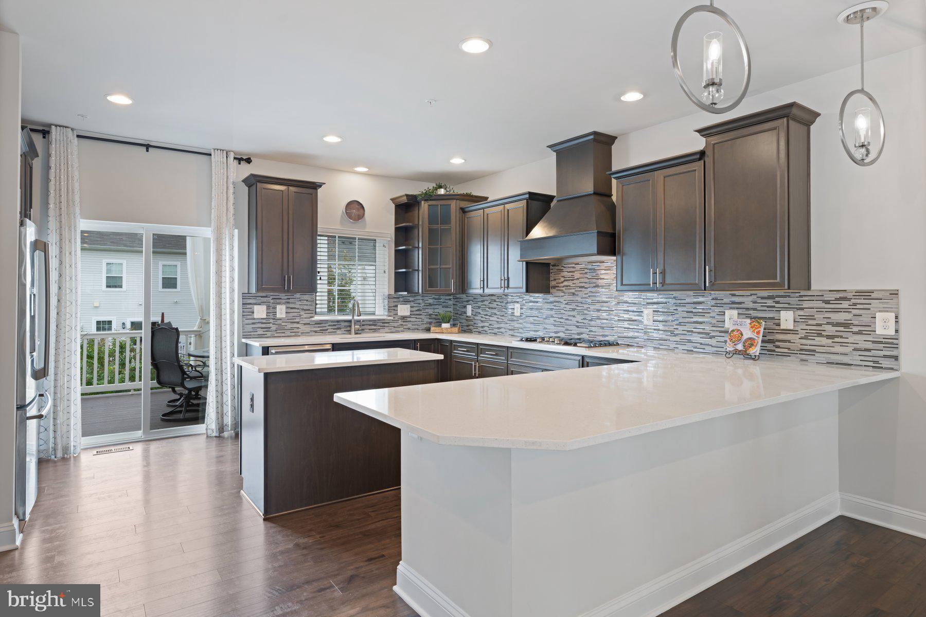 2713 Lady Slipper Road Gambrills, MD 21054 - Photo 15 of 55 a large kitchen with kitchen island a large counter space a sink appliances and cabinets