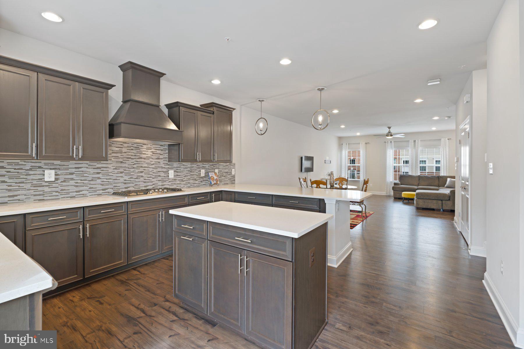 2713 Lady Slipper Road Gambrills, MD 21054 - Photo 18 of 55 a large kitchen with stainless steel appliances kitchen island granite countertop a sink and cabinets