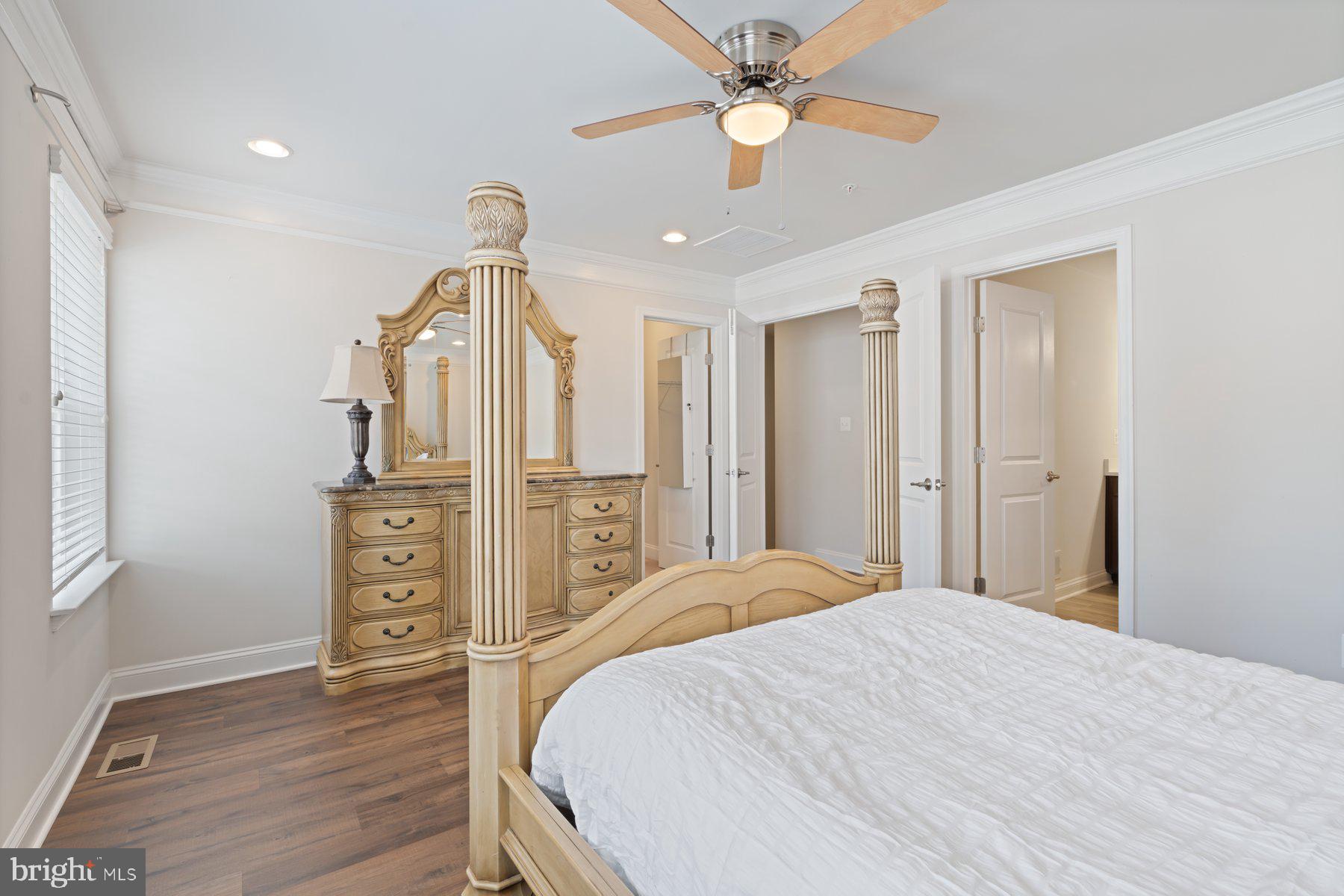 2713 Lady Slipper Road Gambrills, MD 21054 - Photo 24 of 55 a bedroom with a bed ceiling fan and a wooden floor