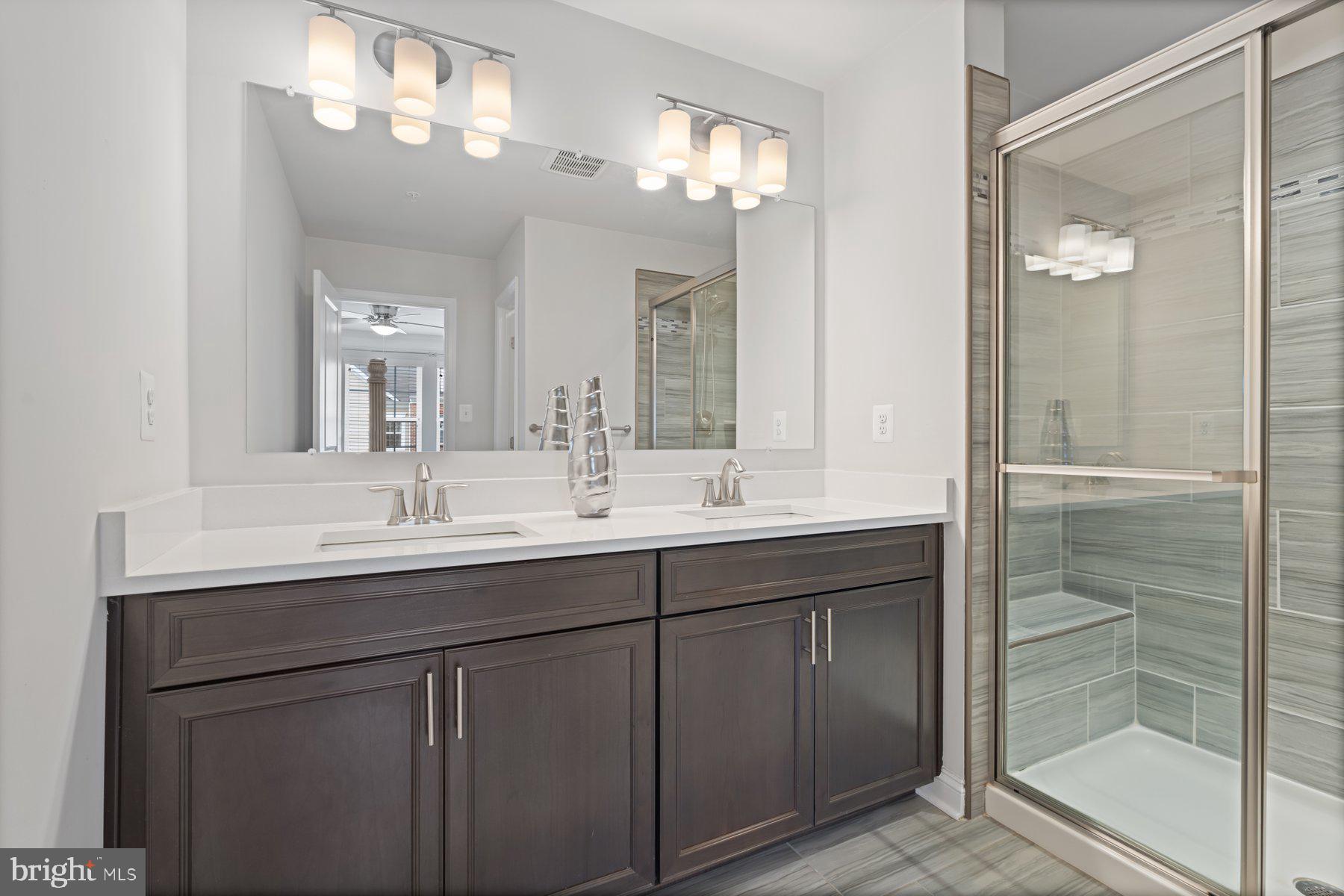2713 Lady Slipper Road Gambrills, MD 21054 - Photo 26 of 55 a bathroom with a double vanity sink and a mirror