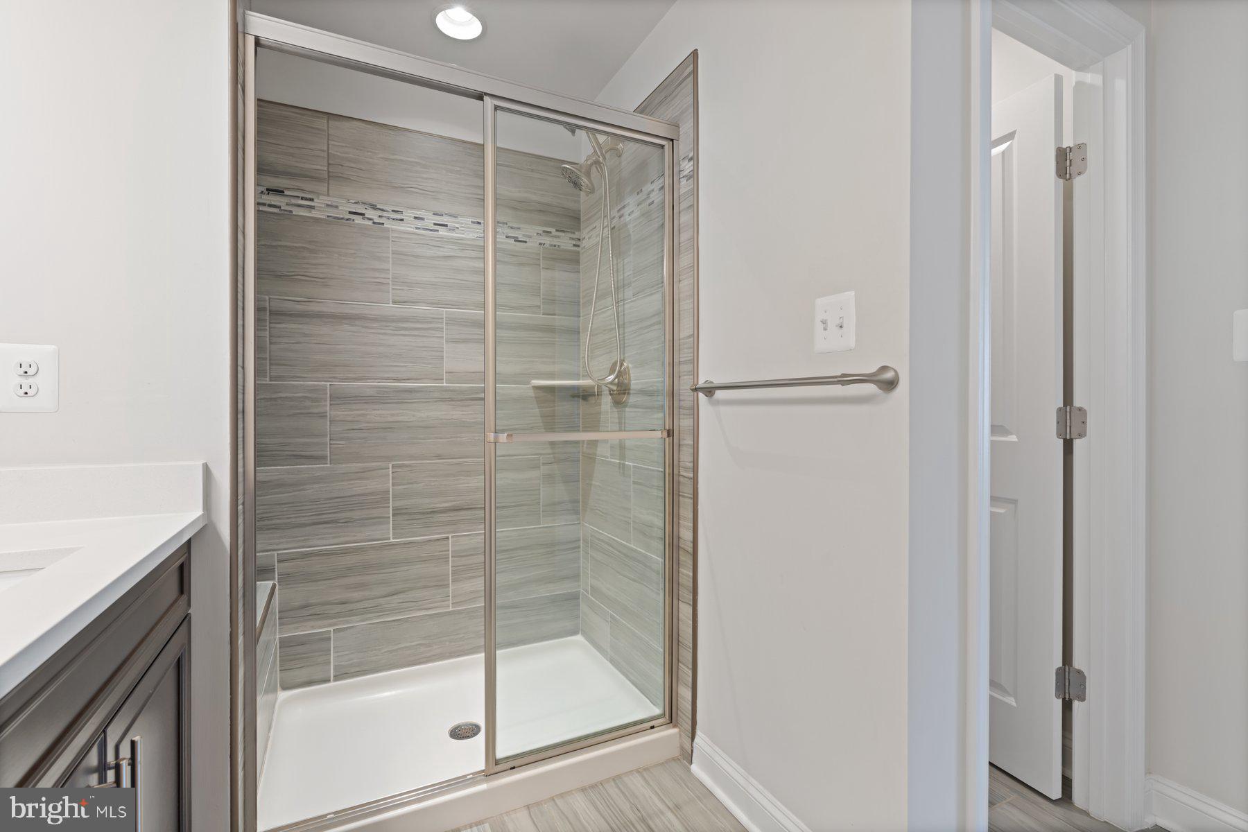 2713 Lady Slipper Road Gambrills, MD 21054 - Photo 27 of 55 a bathroom with a glass shower door