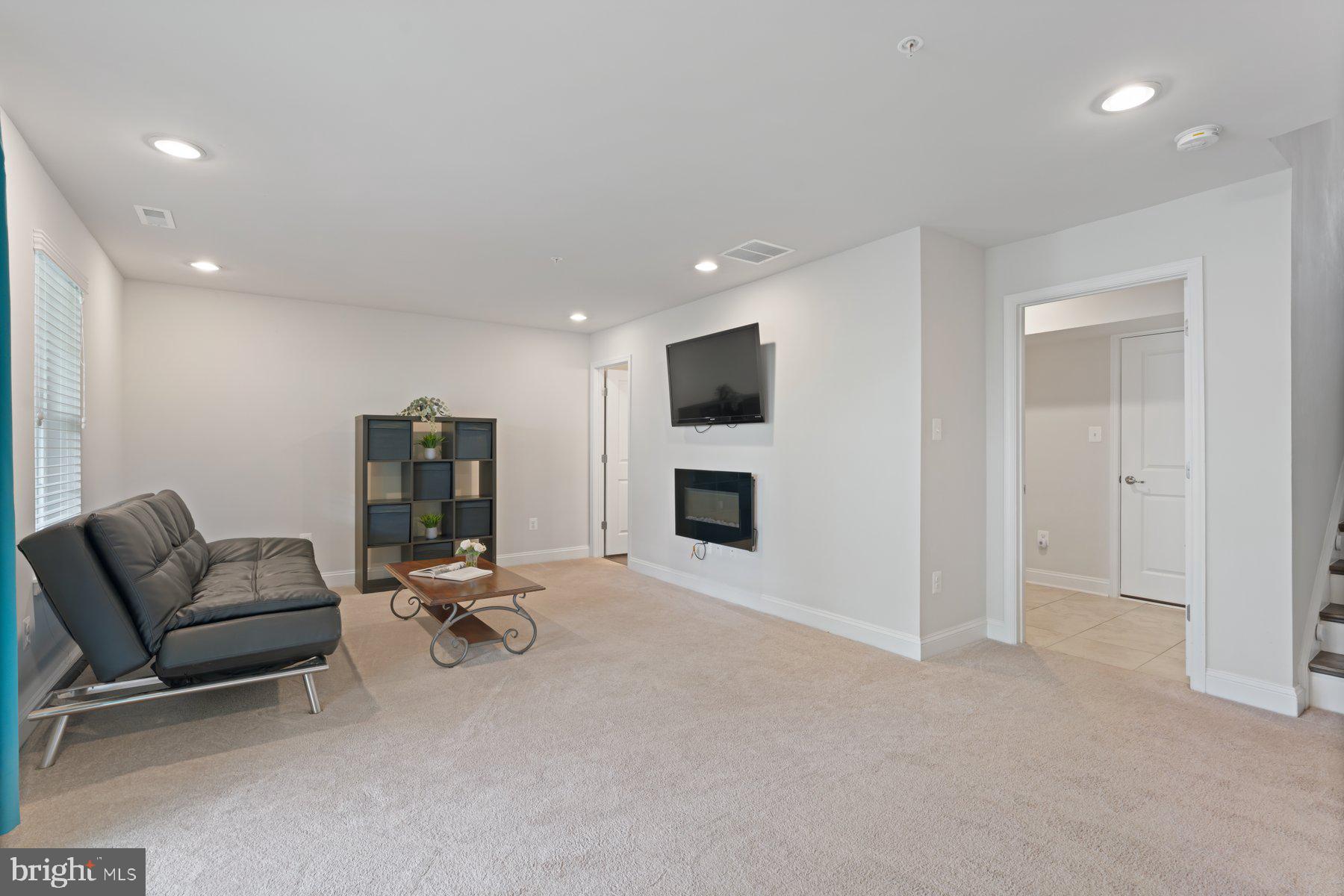 2713 Lady Slipper Road Gambrills, MD 21054 - Photo 35 of 55 a living room with furniture and a fireplace