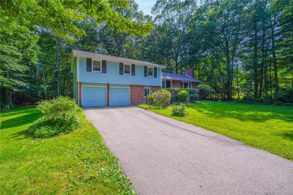 42 Ellise Road Mansfield, CT 06268 - Photo 1 of 1 a front view of a house with a garden and yard
