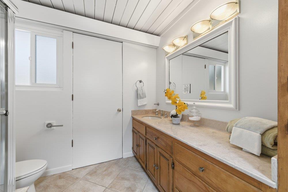2203 Allegheny Way San Mateo, CA 94402 - Photo 17 of 56 a bathroom with a granite countertop sink a toilet and shower
