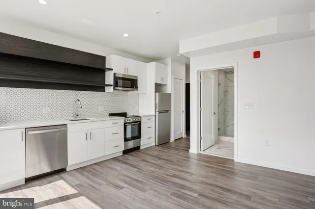 a kitchen with a sink and a stove top oven