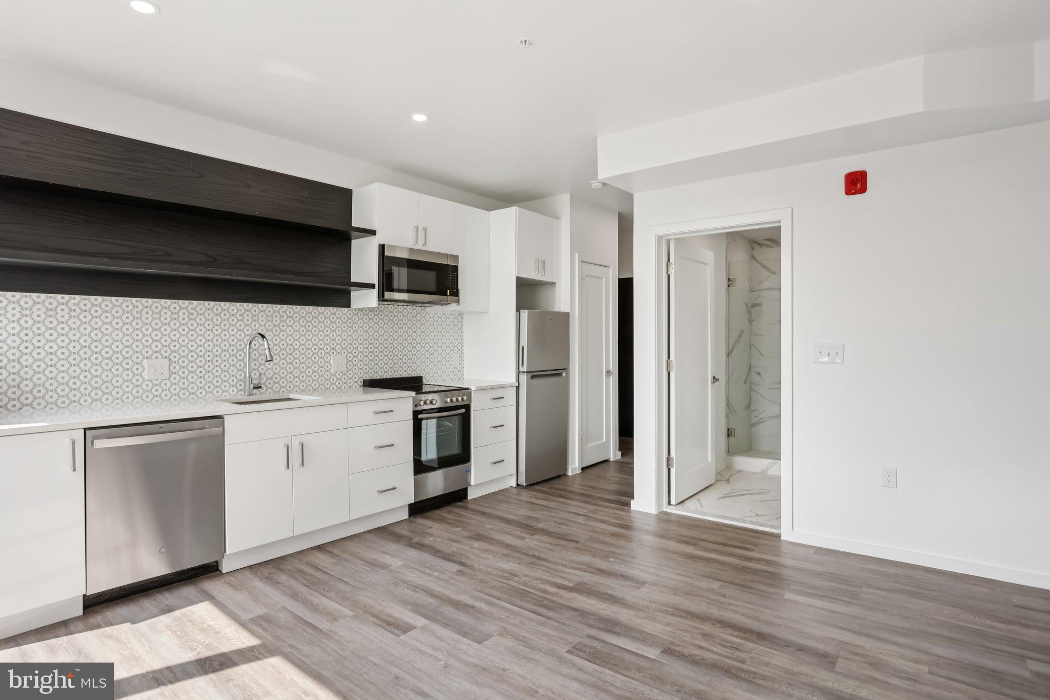 1201 Vine Street, Unit 2 Philadelphia, PA 19107 - Photo 1 of 31 a kitchen with a sink and a stove top oven