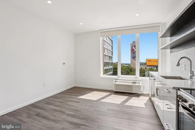 a view of a kitchen with a sink wooden floor and windows