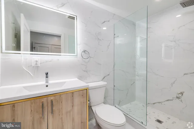 a bathroom with a toilet a sink and shower