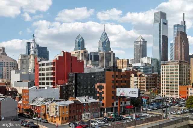 a view of a kitchen with a sink and a refrigerator