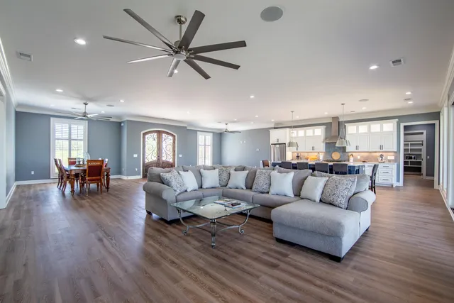 a living room with furniture and wooden floor
