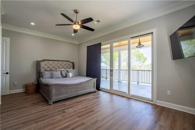 a living room with furniture and a large window with wooden floor
