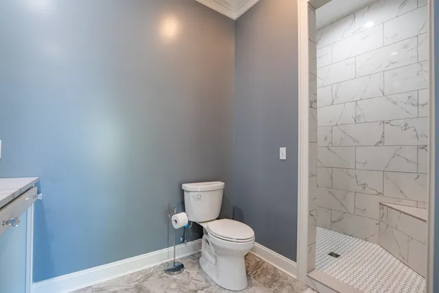a white toilet sitting next to a bath tub