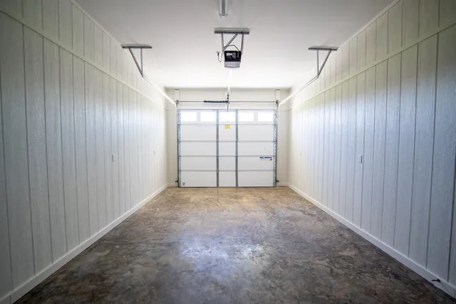 an empty room with windows and cabinet