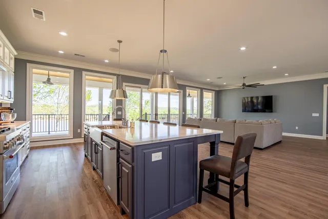 a dining hall with stainless steel appliances granite countertop a stove and a refrigerator