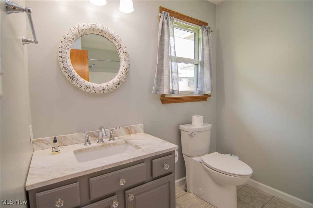 53350 High Ridge Road Bridgeport, OH 43912 - Photo 16 of 37 Bathroom with vanity, toilet, baseboards, and tile patterned floors