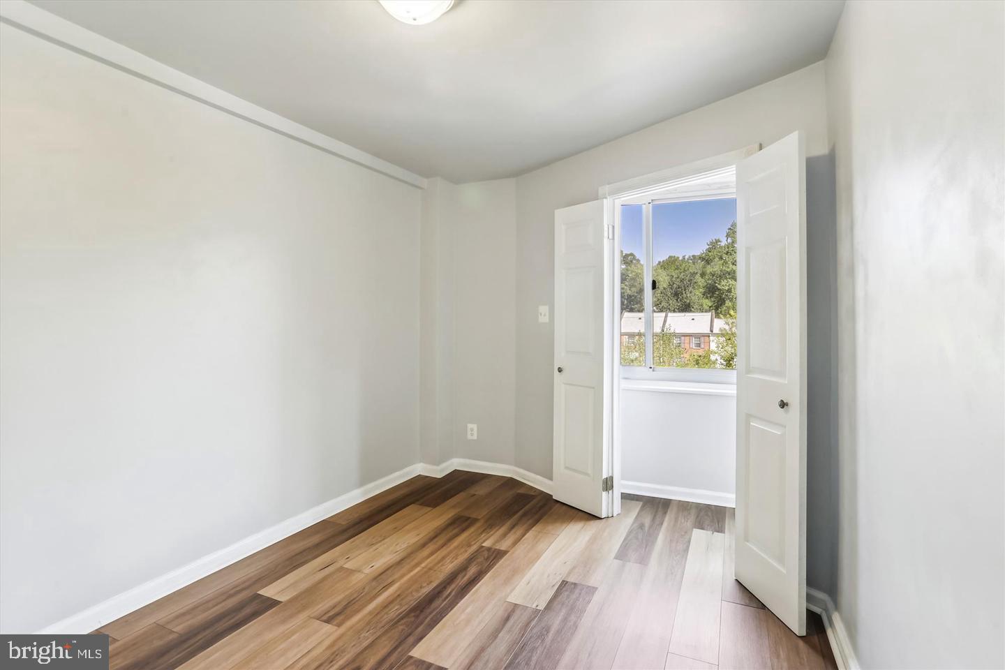 1900 Lyttonsville Road, Unit 602 Silver Spring, MD 20910 - Photo 11 of 43 a view of a room with wooden floor and window