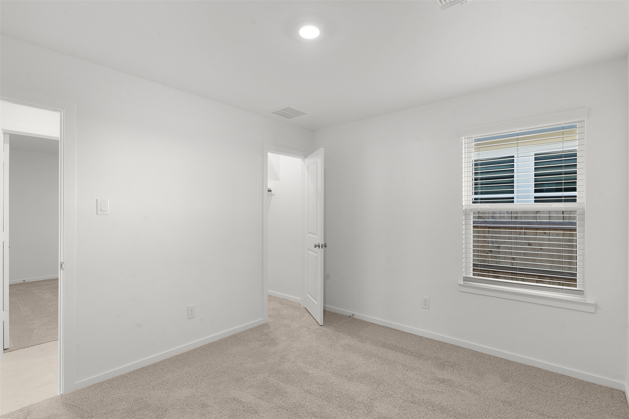 13832 Scarlett Song Drive Elgin, TX 78621 - Photo 16 of 26 Empty room with light carpet and baseboards