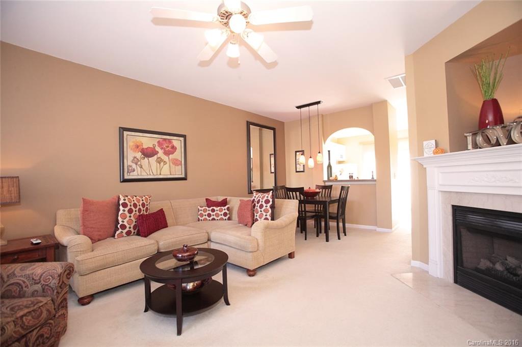 831 Gentlewinds Court, Unit 122 Fort Mill, SC 29708 - Photo 2 of 19 a living room with furniture and a fireplace