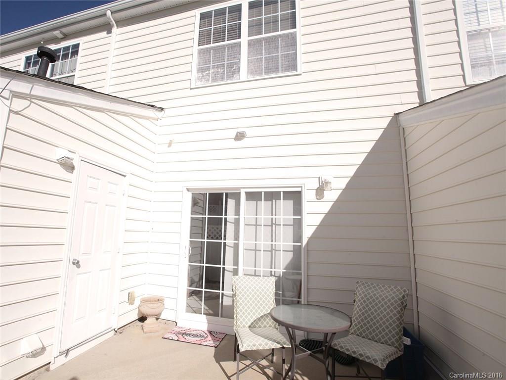 831 Gentlewinds Court, Unit 122 Fort Mill, SC 29708 - Photo 16 of 19 a view of a patio with a table and chairs and potted plants