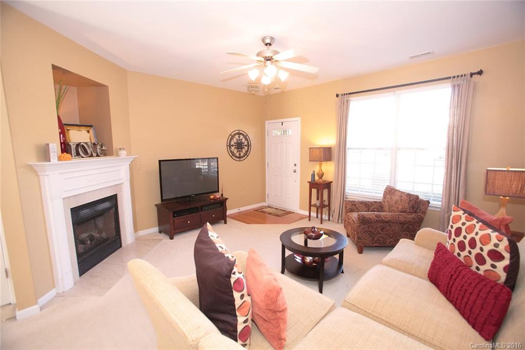 831 Gentlewinds Court, Unit 122 Fort Mill, SC 29708 - Photo 4 of 19 a living room with furniture and a fireplace
