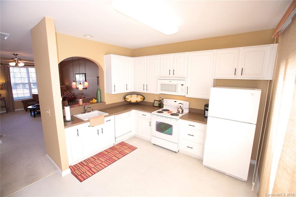 831 Gentlewinds Court, Unit 122 Fort Mill, SC 29708 - Photo 5 of 19 a kitchen with a refrigerator and white cabinets
