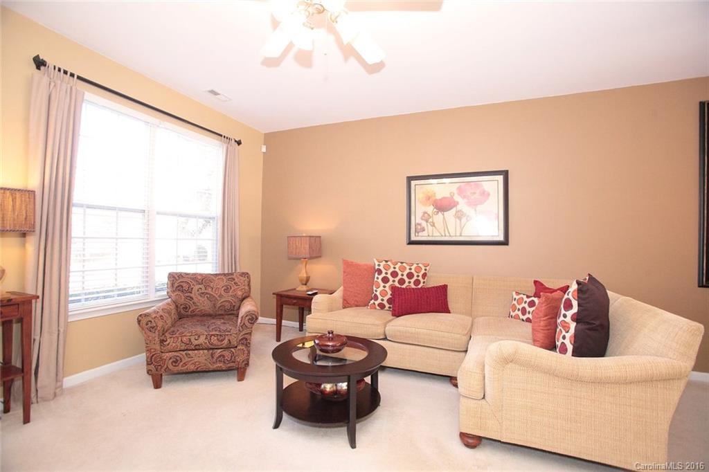 831 Gentlewinds Court, Unit 122 Fort Mill, SC 29708 - Photo 6 of 19 a living room with furniture and a large window