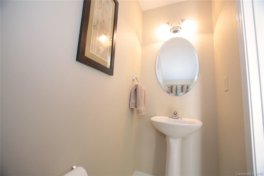 831 Gentlewinds Court, Unit 122 Fort Mill, SC 29708 - Photo 9 of 19 a bathroom with a sink and a mirror