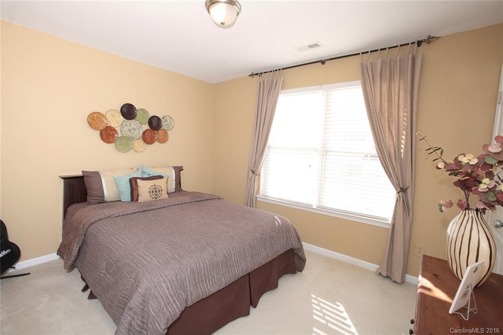 831 Gentlewinds Court, Unit 122 Fort Mill, SC 29708 - Photo 10 of 19 a bedroom with a bed and a window