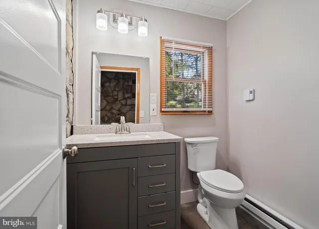 a kitchen with stainless steel appliances granite countertop a sink a stove top oven a refrigerator and cabinets