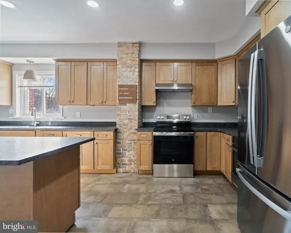 a kitchen with stainless steel appliances a stove and a refrigerator