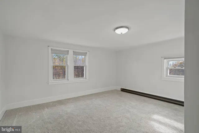 a bathroom with a granite countertop sink mirror and toilet