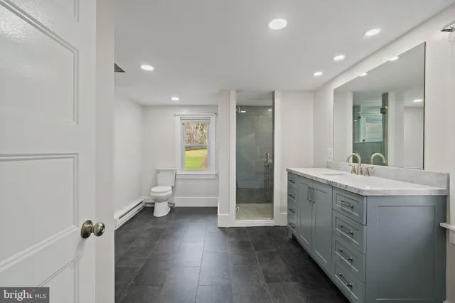 a spacious bathroom with a double vanity sink a mirror and a vanity