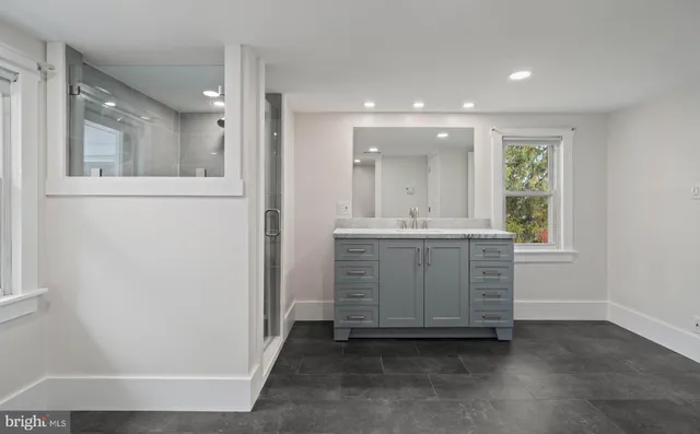 a bedroom with a bed chair and window
