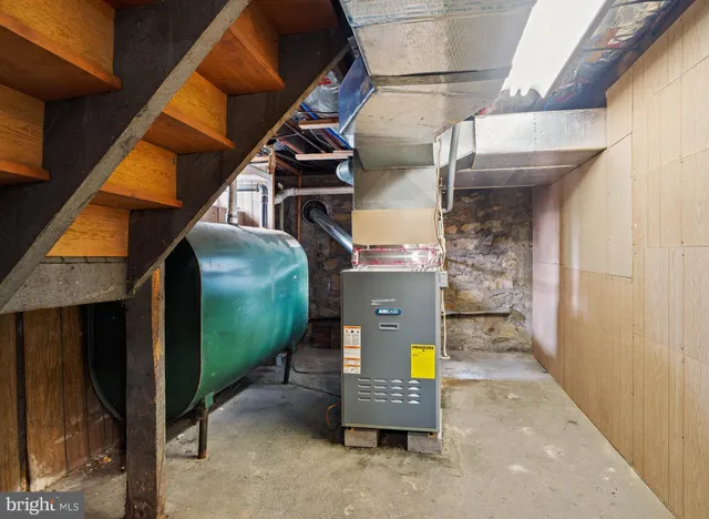 an aerial view of a swimming pool with outdoor seating and yard