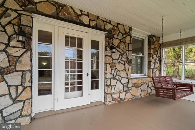 a view of a house with a patio and a yard