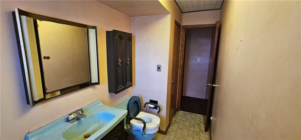 404 Ridgelawn Avenue New Castle, PA 16105 - Photo 16 of 34 a bathroom with a sink and a mirror