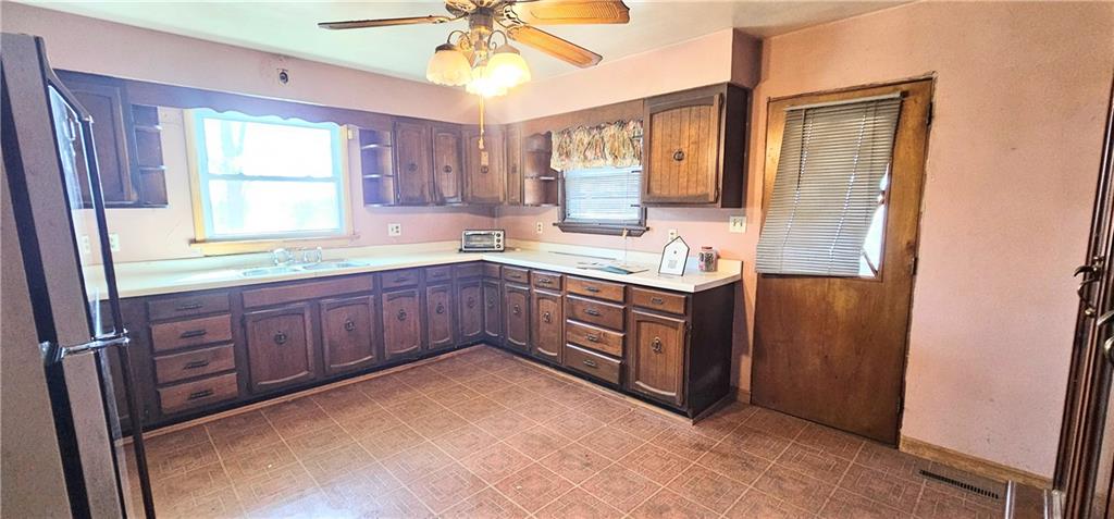 404 Ridgelawn Avenue New Castle, PA 16105 - Photo 6 of 34 a kitchen with a sink window and cabinets
