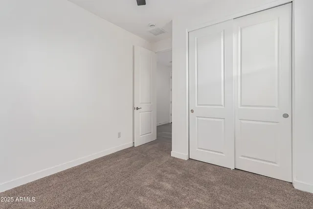 an empty room with closet area