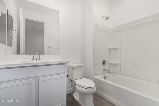 a bathroom with a sink toilet vanity and bathtub