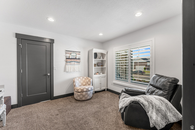 313 Old Maple Road South Weber, UT 84405 - Photo 5 of 35 Recessed lighting illuminates the room, featuring a window with white plantation shutters and a dark gray door with coordinating trim and baseboard