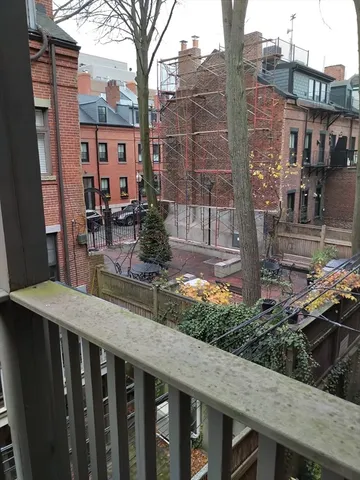 a view of a house with brick walls