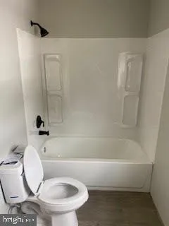 a bathroom with a toilet and a bathtub