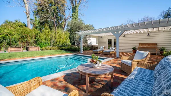 a view of a backyard with sitting area