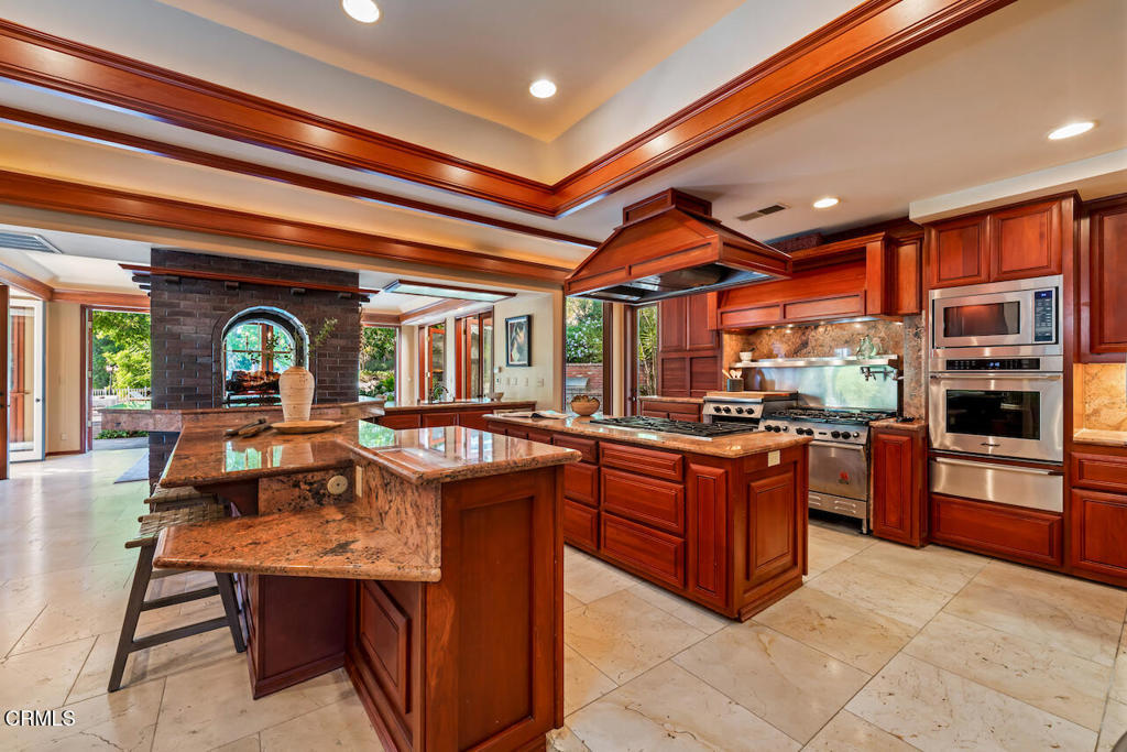 427 Long Canyon Road Bradbury, CA 91008 - Photo 13 of 62 a kitchen with stainless steel appliances granite countertop a stove and a refrigerator