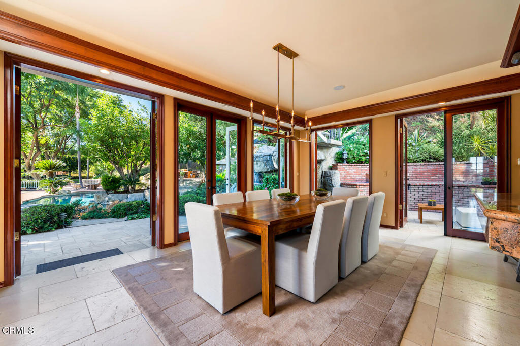 427 Long Canyon Road Bradbury, CA 91008 - Photo 17 of 62 a dining room with furniture and floor to ceiling windows