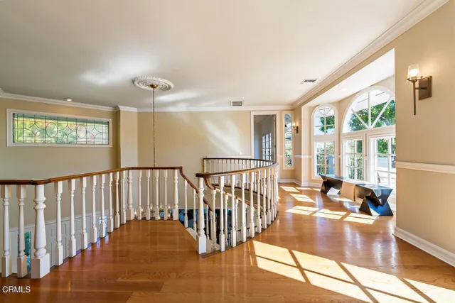 a living room with furniture and large windows
