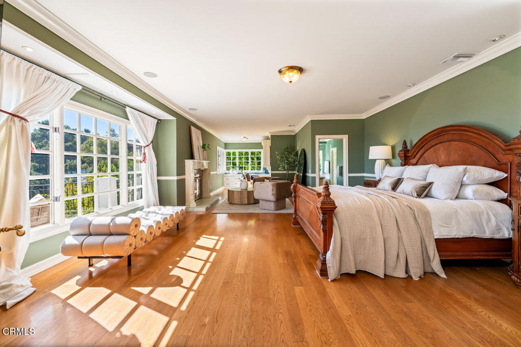 427 Long Canyon Road Bradbury, CA 91008 - Photo 21 of 62 a spacious bedroom with a bed and glass windows