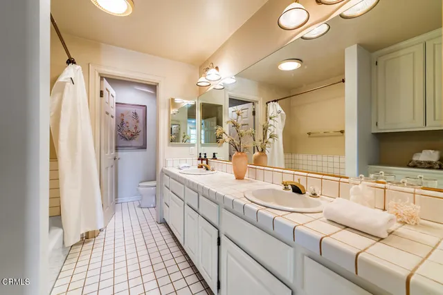 a patio with wooden floor a yard a table and chairs