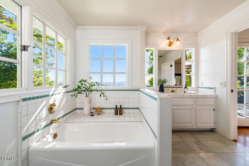 427 Long Canyon Road Bradbury, CA 91008 - Photo 34 of 62 a bathroom with a tub a sink and a large window