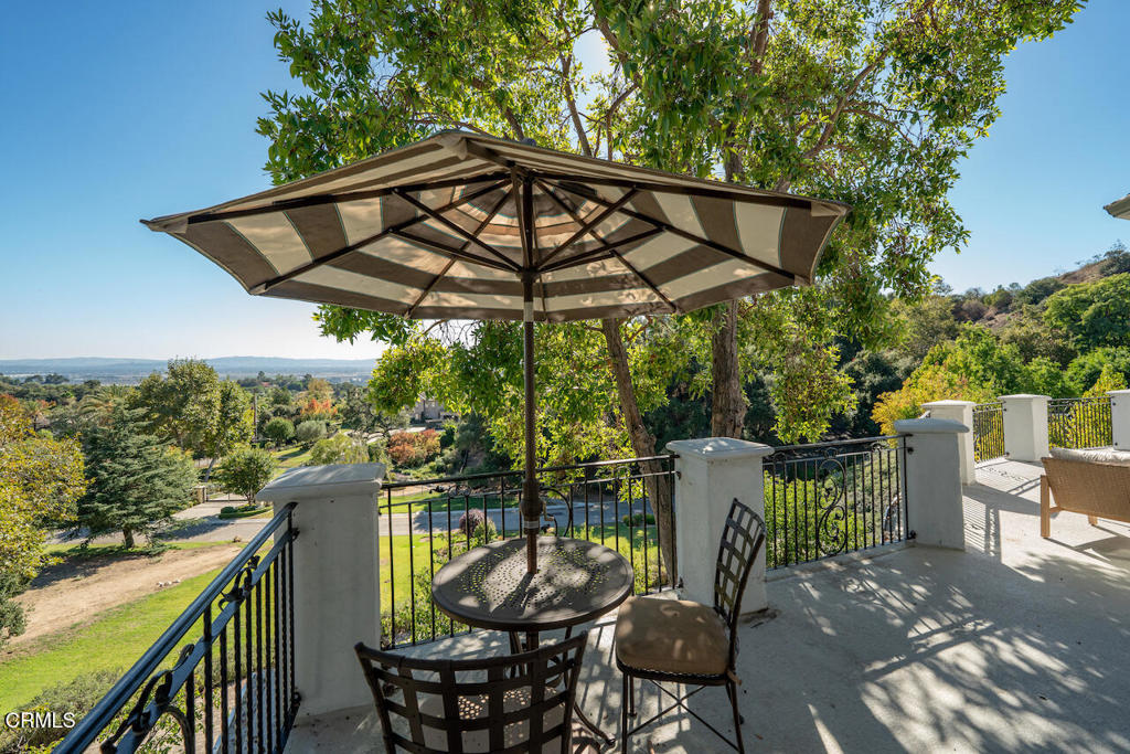 427 Long Canyon Road Bradbury, CA 91008 - Photo 35 of 62 a patio with wooden floor a yard a table and chairs